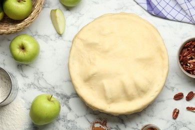 Photo of Flat lay composition with raw homemade apple pie and ingredients on white marble table