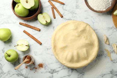 Photo of Flat lay composition with raw homemade apple pie and ingredients on white marble table