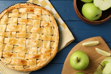 Photo of Flat lay composition with tasty homemade apple pie and ingredients on blue wooden table