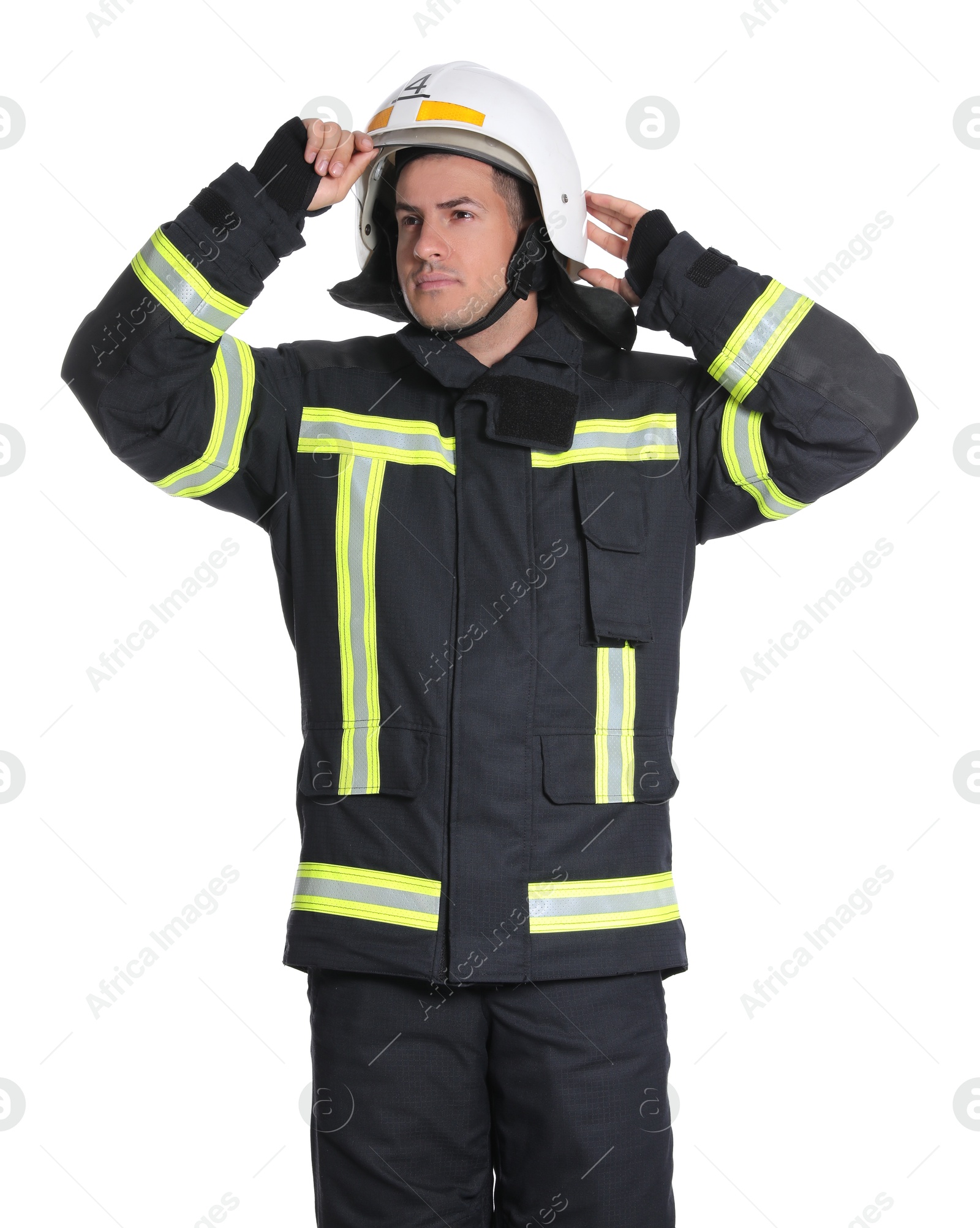 Photo of Portrait of firefighter in uniform wearing helmet on white background