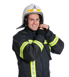 Photo of Portrait of firefighter in uniform wearing helmet on white background