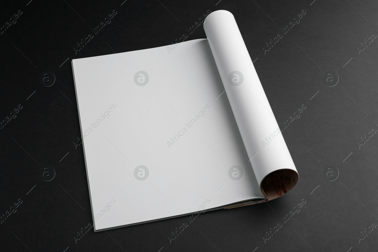 Photo of Open magazine with blank page on black background. Mockup for design