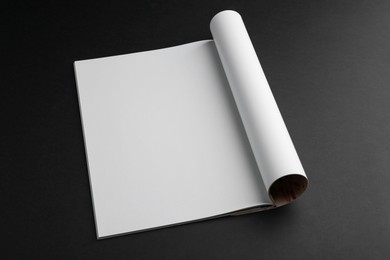 Photo of Open magazine with blank page on black background. Mockup for design