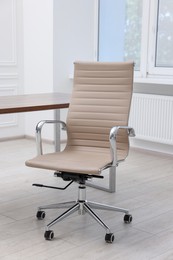 Beige leather chair and desk in office