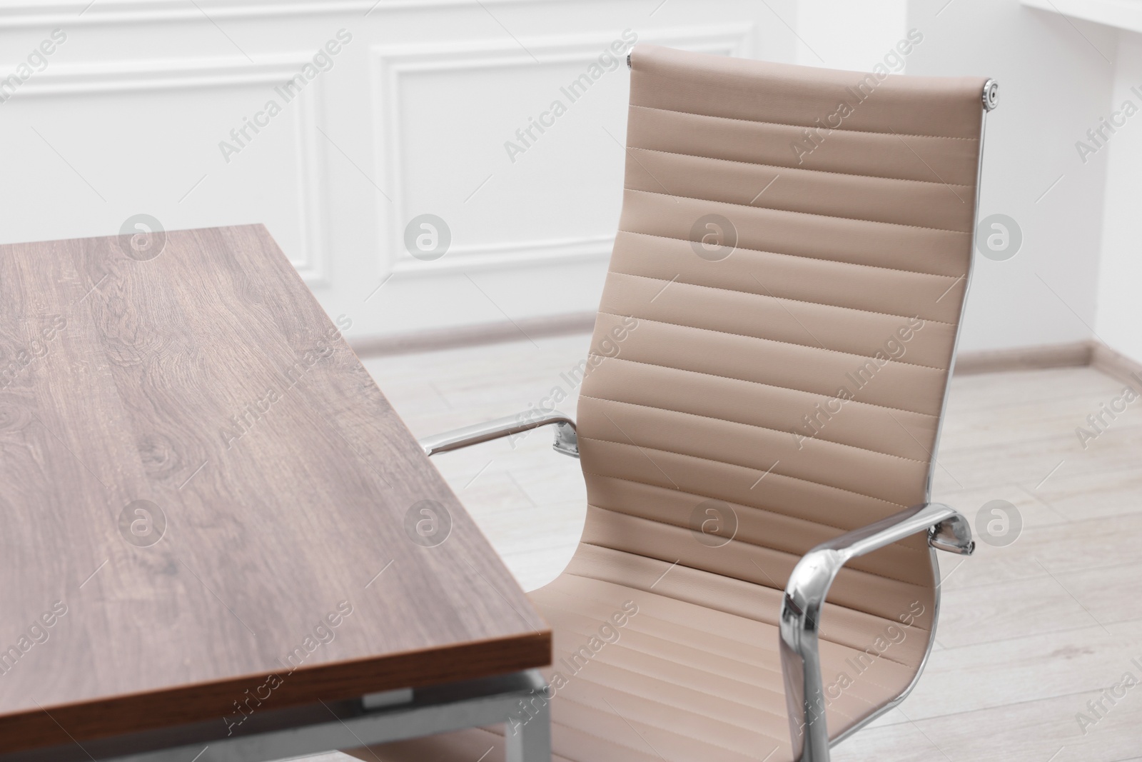 Photo of Beige leather chair and desk in office