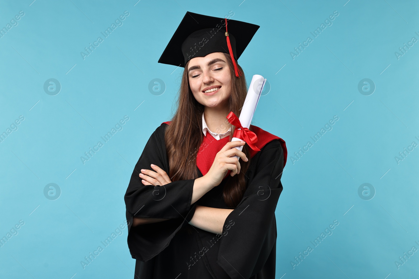 Photo of Happy student with diploma after graduation on light blue background