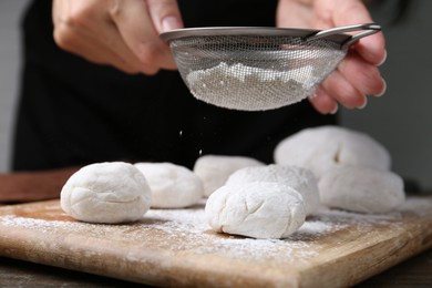 Photo of Woman making tasty mochi at wooden table, closeup