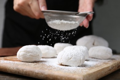 Photo of Woman making tasty mochi at wooden table, closeup