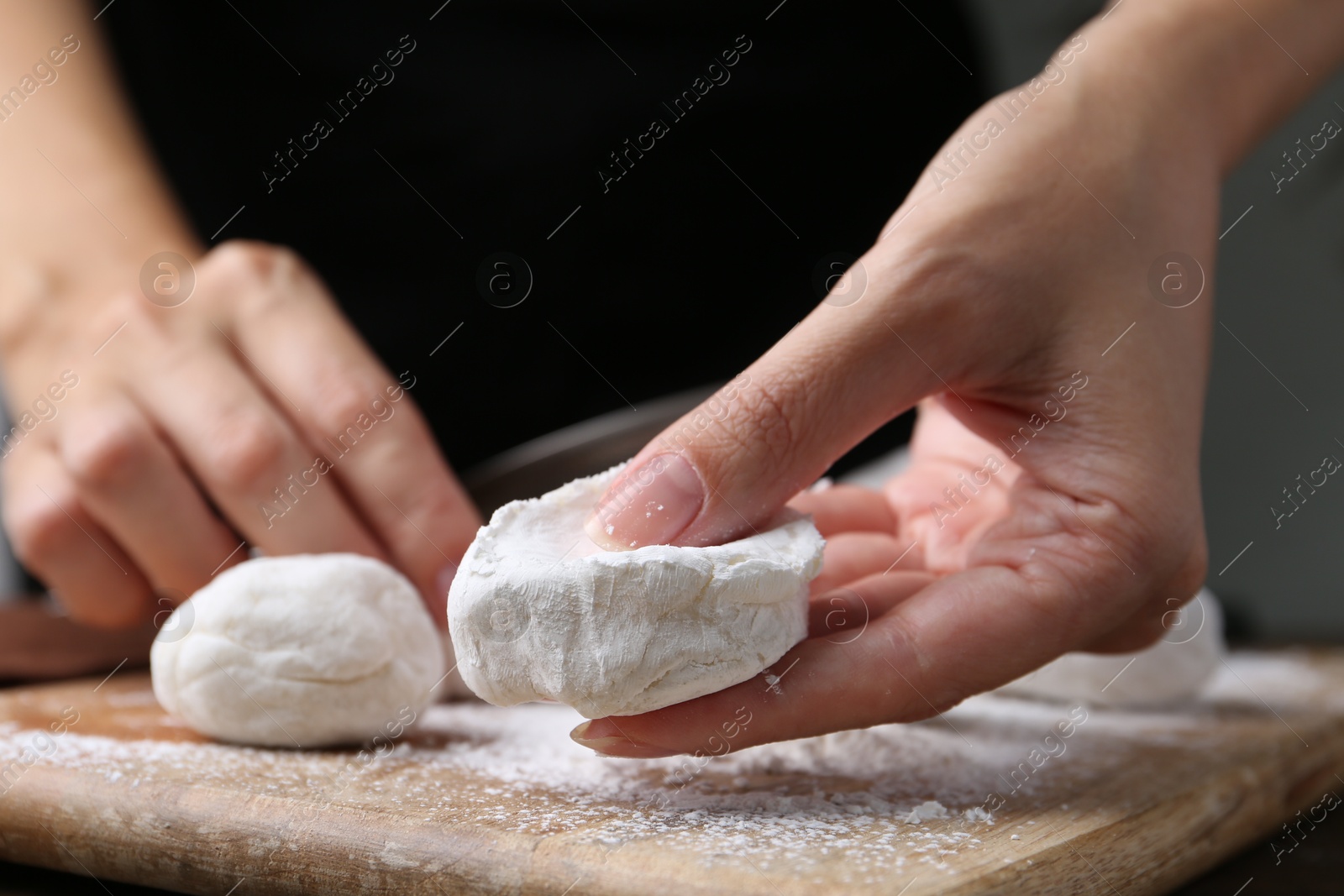 Photo of Woman making tasty mochi at wooden table, closeup