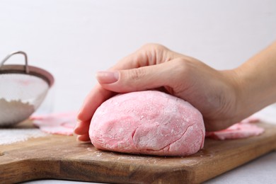 Photo of Woman making tasty mochi at white table, closeup