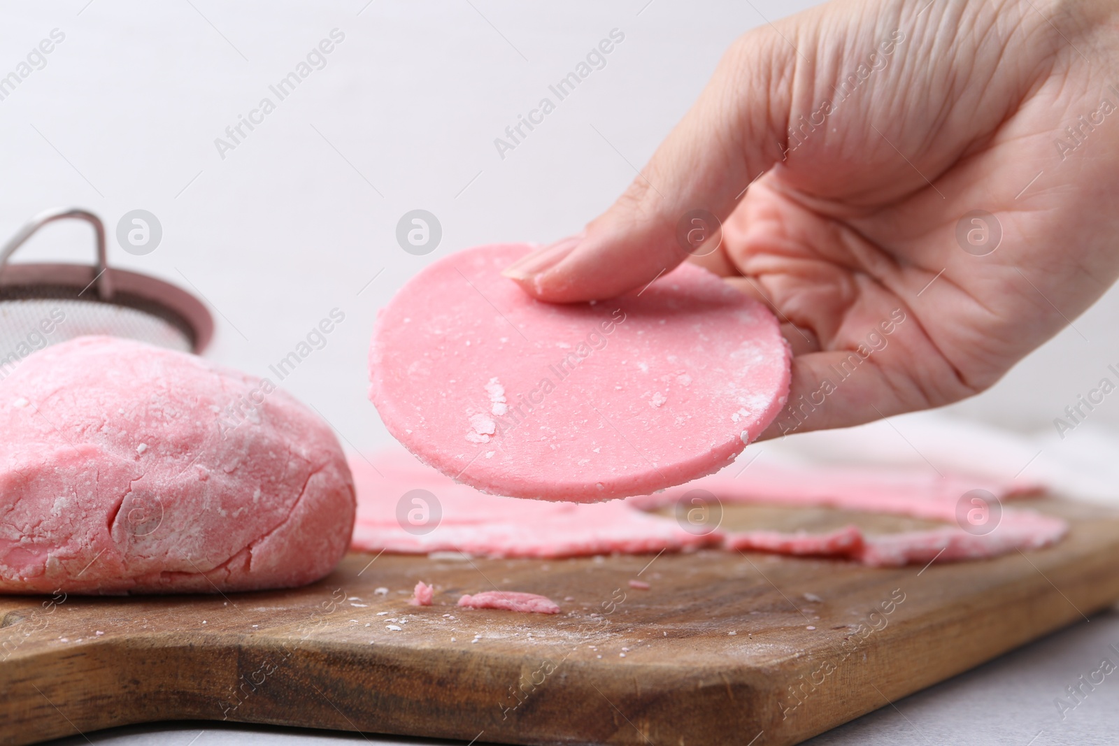 Photo of Woman making tasty mochi at white table, closeup