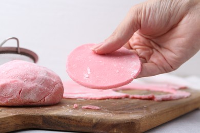 Photo of Woman making tasty mochi at white table, closeup