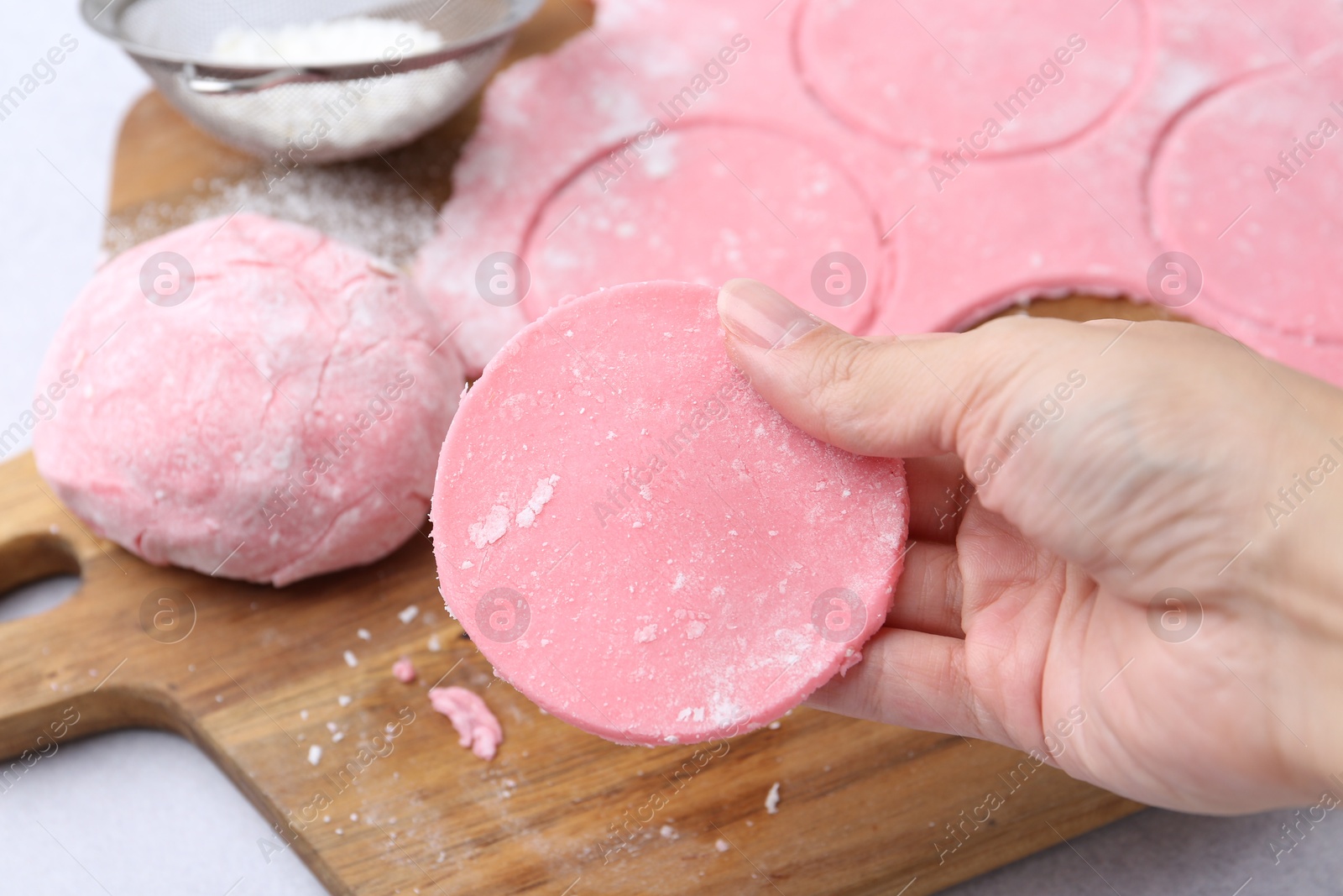 Photo of Woman making tasty mochi at white table, closeup