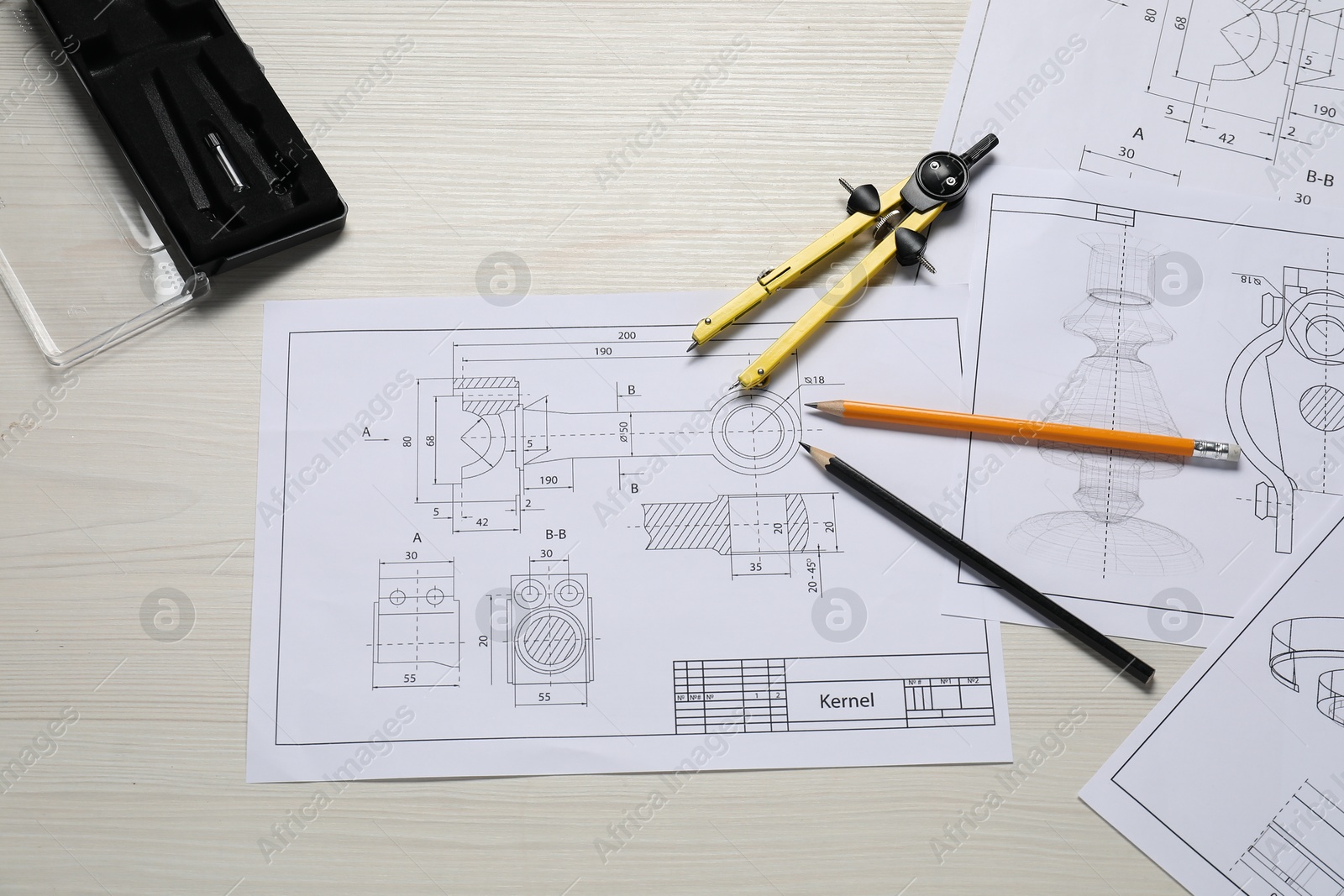 Photo of Different engineering drawings, pencils and divider on wooden table, flat lay