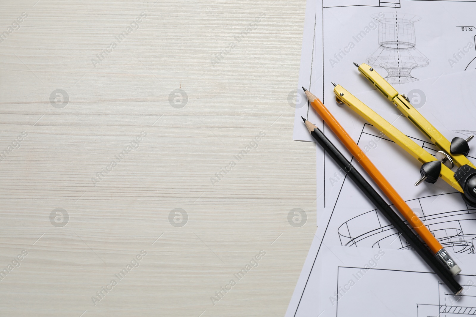 Photo of Different engineering drawings, pencils and divider on wooden table, flat lay. Space for text