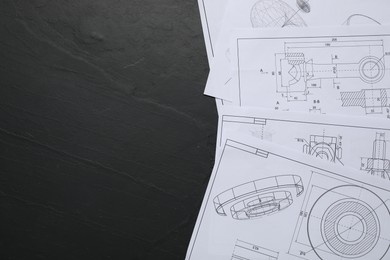 Photo of Different engineering drawings on grey textured table, flat lay. Space for text