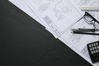 Different engineering drawings, pencil, divider and calculator on grey textured table, flat lay. Space for text