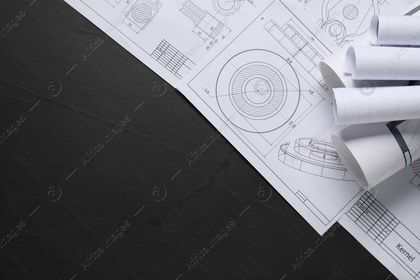 Photo of Different engineering drawings on grey textured table, flat lay. Space for text