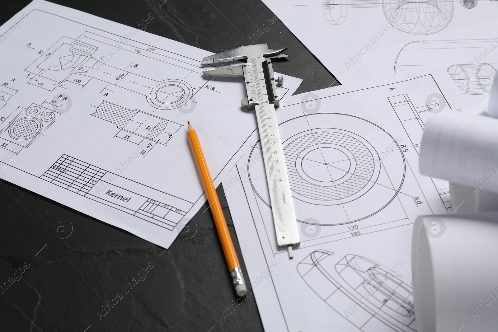 Photo of Different engineering drawings, ruler and pencil on grey textured table