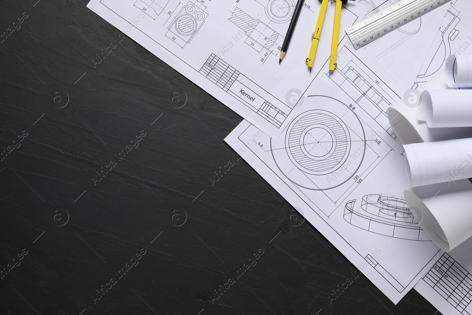 Photo of Different engineering drawings, ruler, divider and pencil on grey textured table, flat lay. Space for text