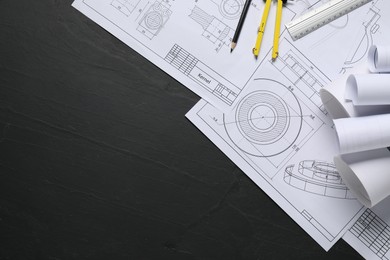 Photo of Different engineering drawings, ruler, divider and pencil on grey textured table, flat lay. Space for text