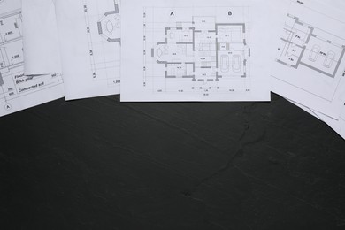 Different architectural drawings on grey textured table, flat lay. Space for text