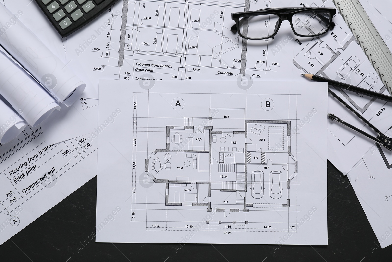 Photo of Different architectural drawings, ruler, divider and pencil on grey textured table, flat lay