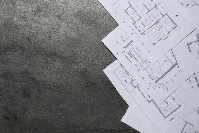 Photo of Different architectural drawings on grey textured table, flat lay. Space for text