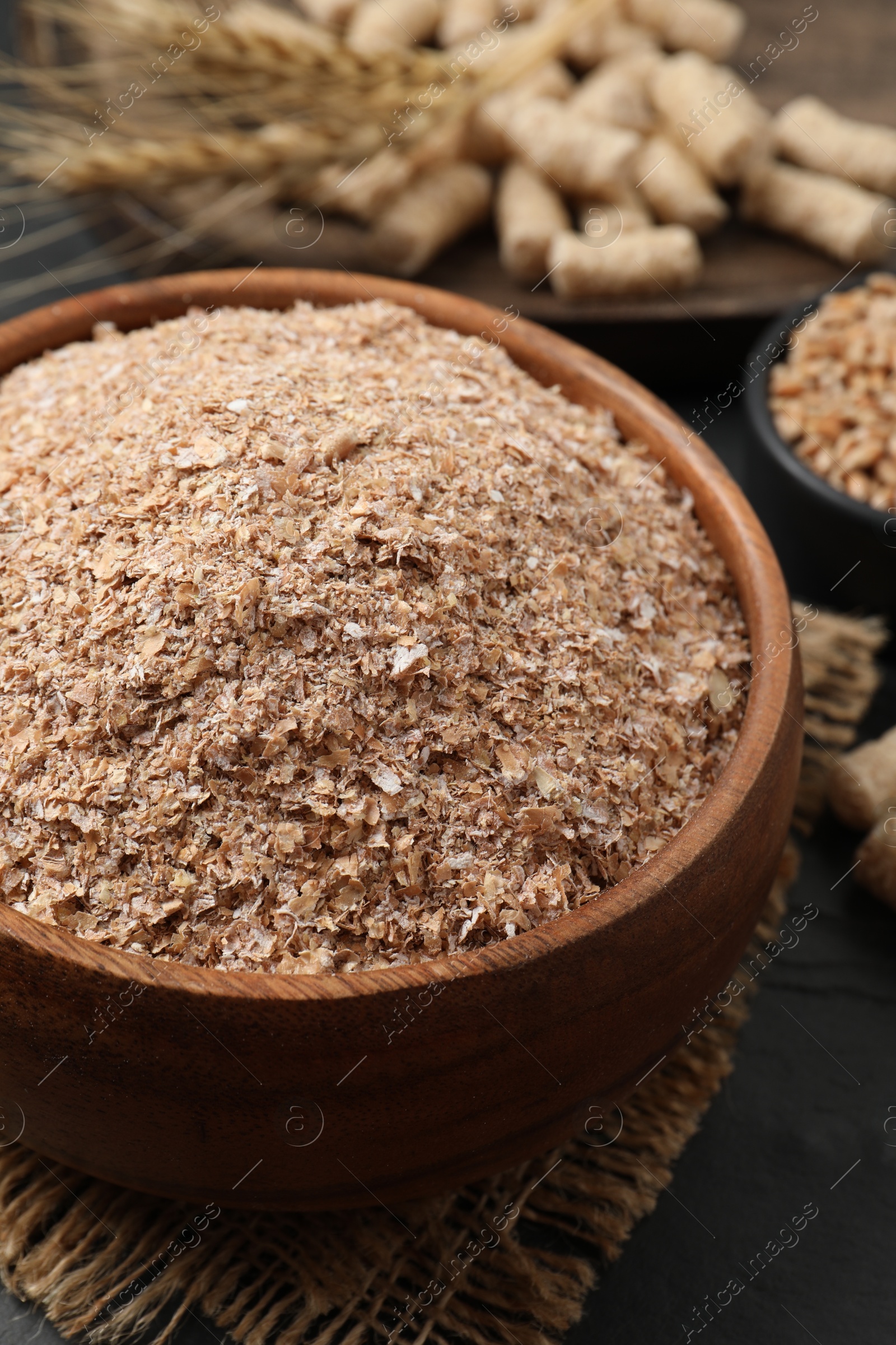 Photo of Wheat bran in bowl on black table