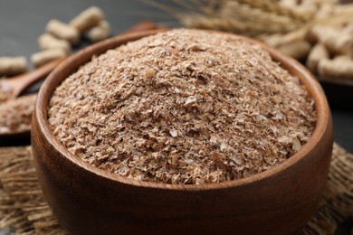 Wheat bran in bowl on table, closeup