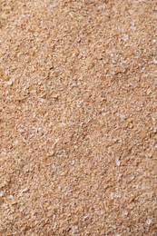 Photo of Heap of wheat bran as background, top view