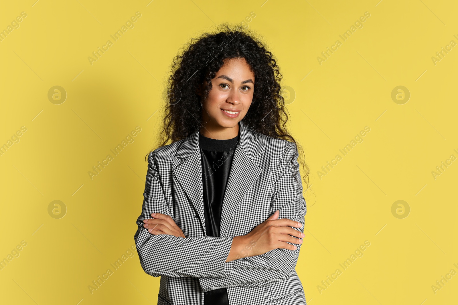 Photo of Beautiful woman in stylish jacket on yellow background