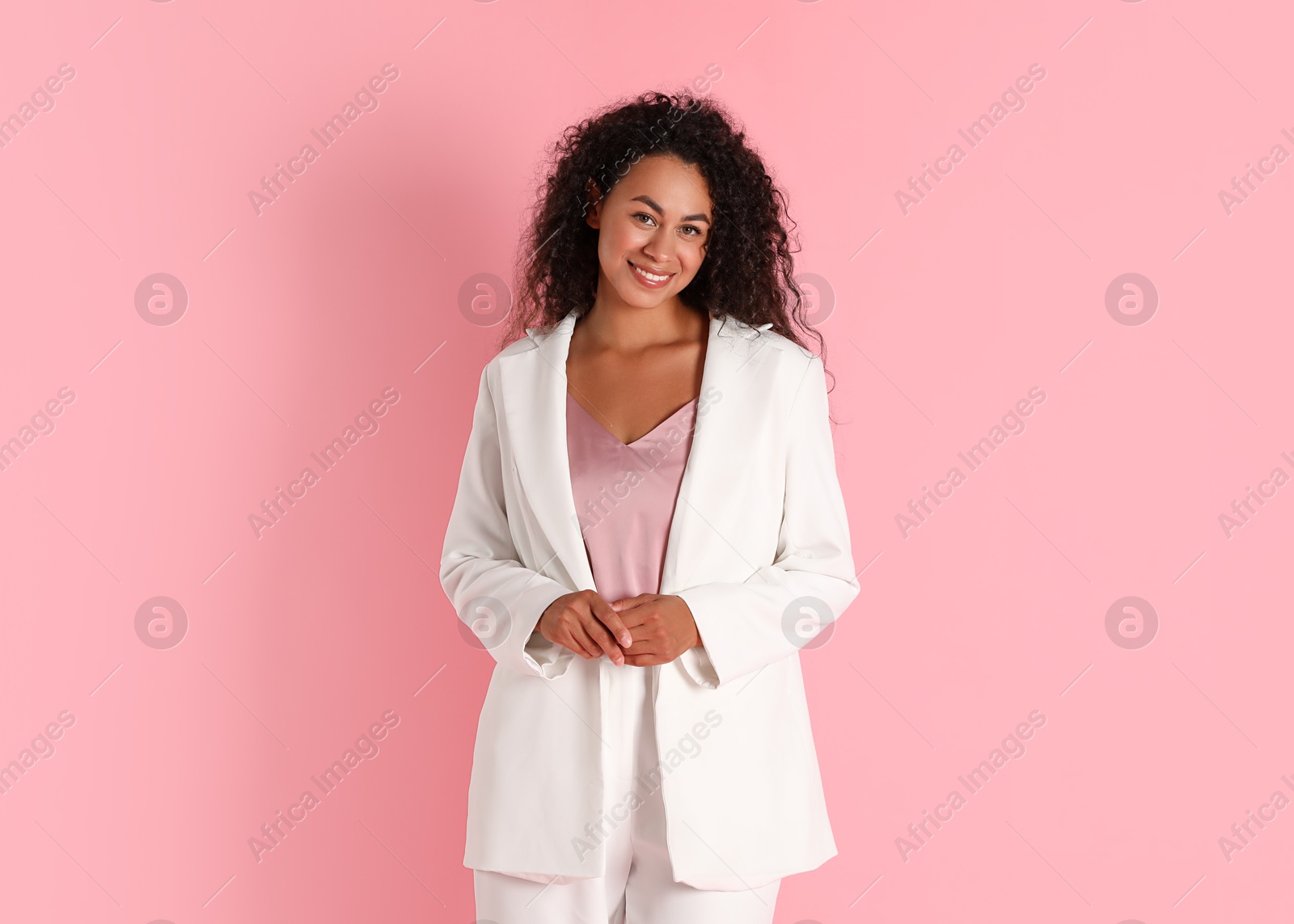 Photo of Beautiful woman in stylish suit on pink background