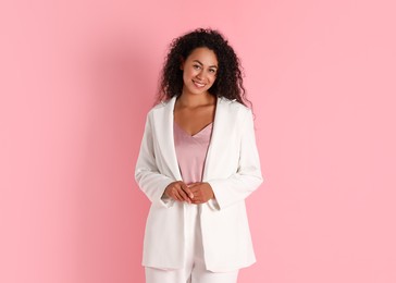 Photo of Beautiful woman in stylish suit on pink background