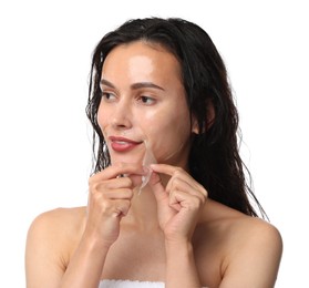 Beautiful woman peeling off face mask on white background