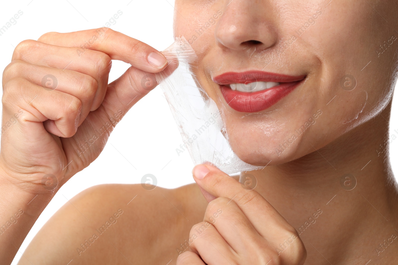 Photo of Smiling woman peeling off face mask on white background, closeup