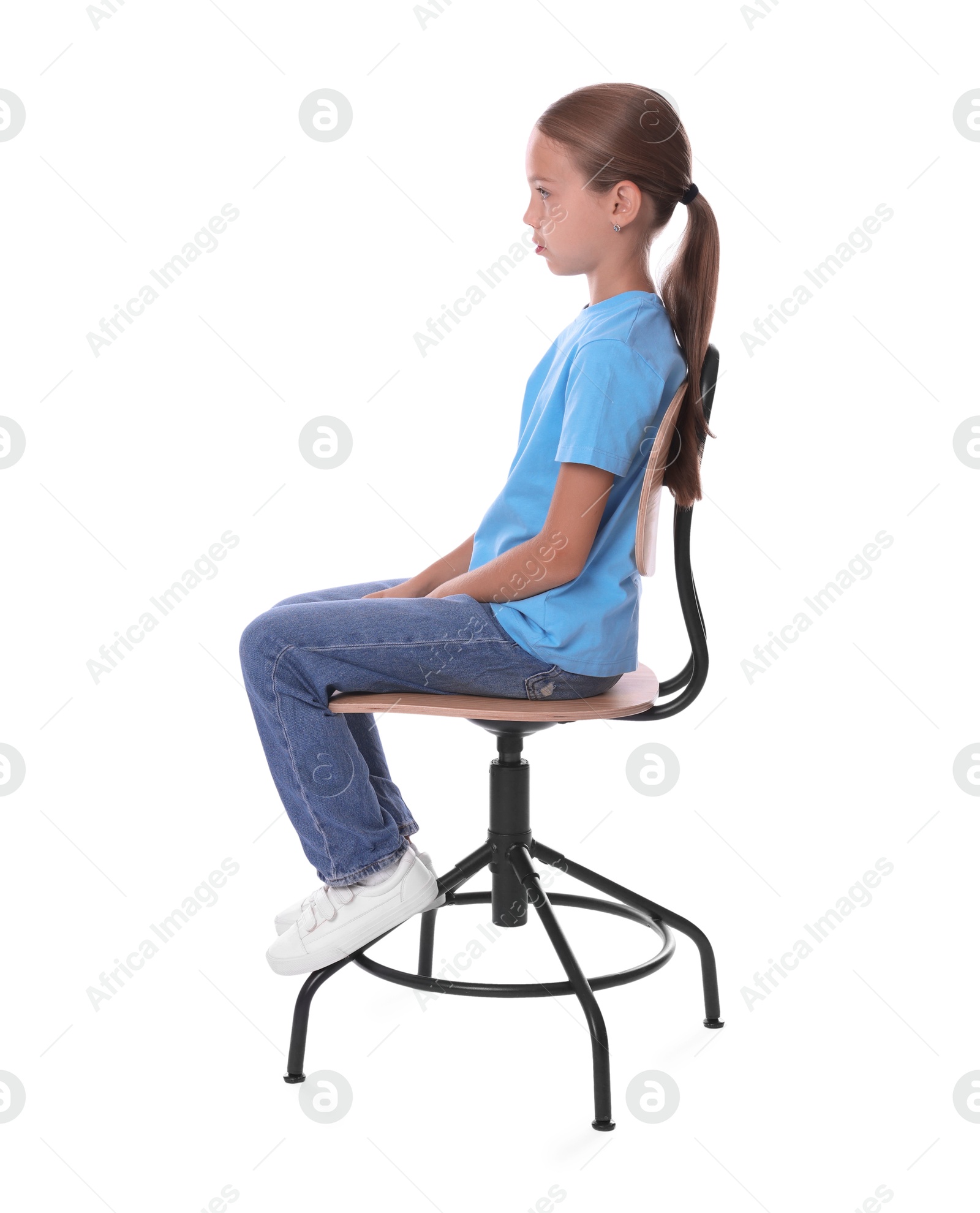 Photo of Girl with correct posture sitting on chair against white background