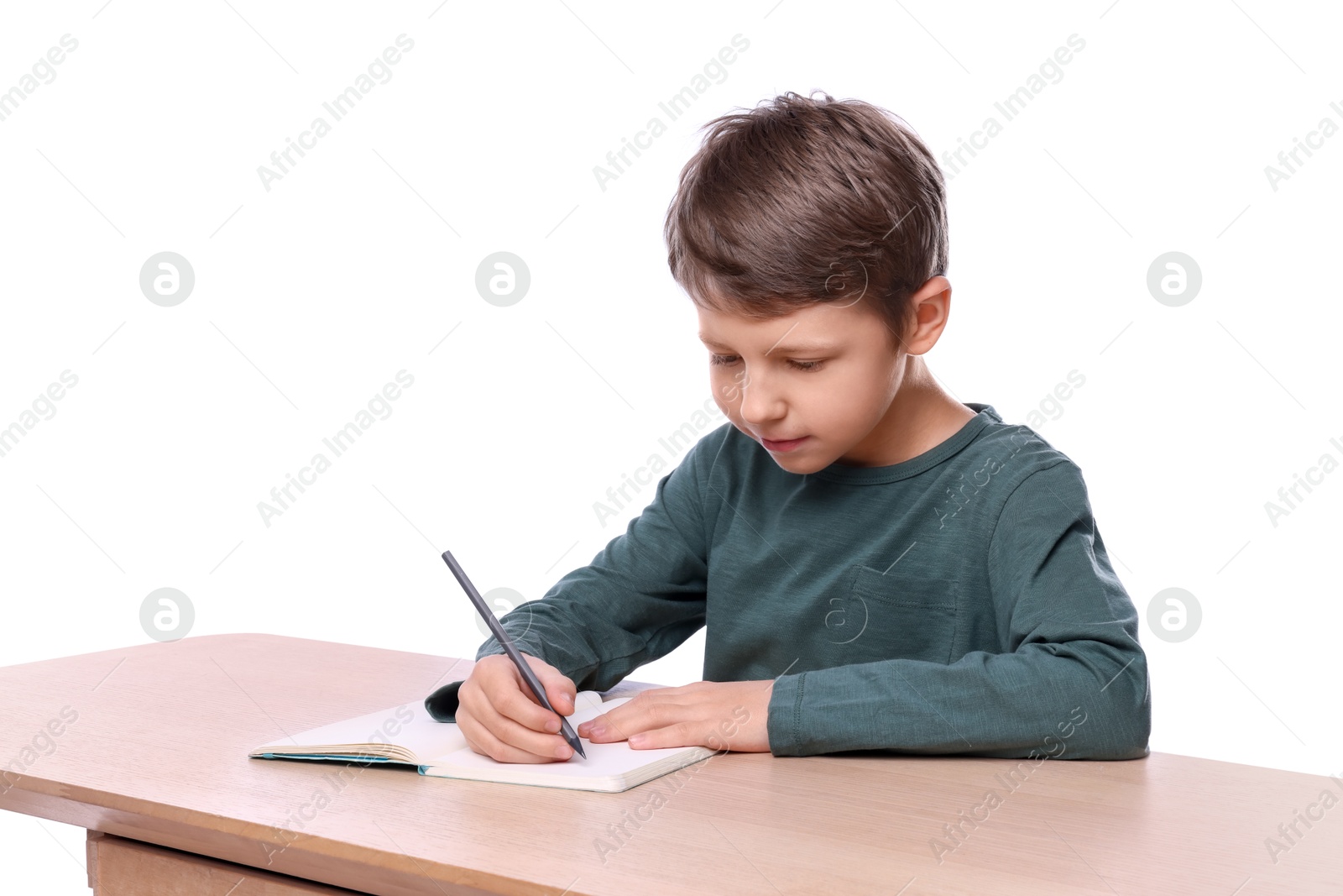 Photo of Boy with correct posture and notebook at wooden desk on white background