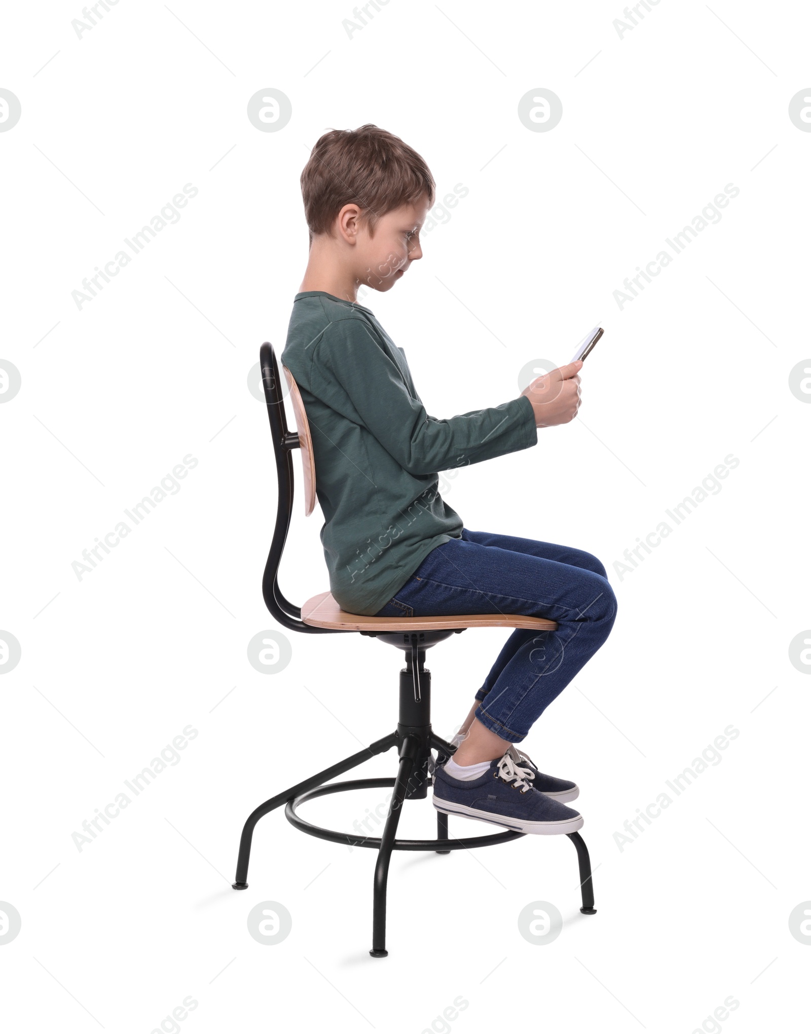 Photo of Boy with correct posture and phone sitting on chair against white background