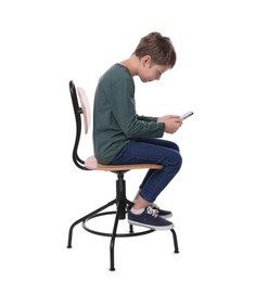 Boy with incorrect posture and phone sitting on chair against white background