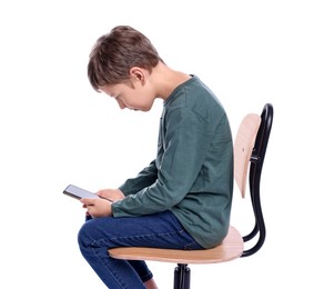 Boy with incorrect posture and phone sitting on chair against white background