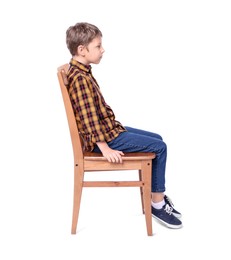 Boy with correct posture sitting on chair against white background