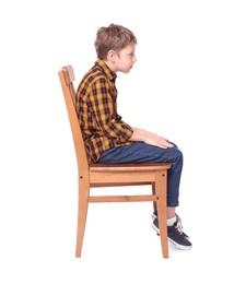 Photo of Boy with incorrect posture sitting on chair against white background