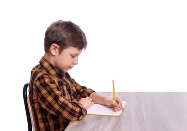 Photo of Boy with correct posture and notebook at wooden desk on white background