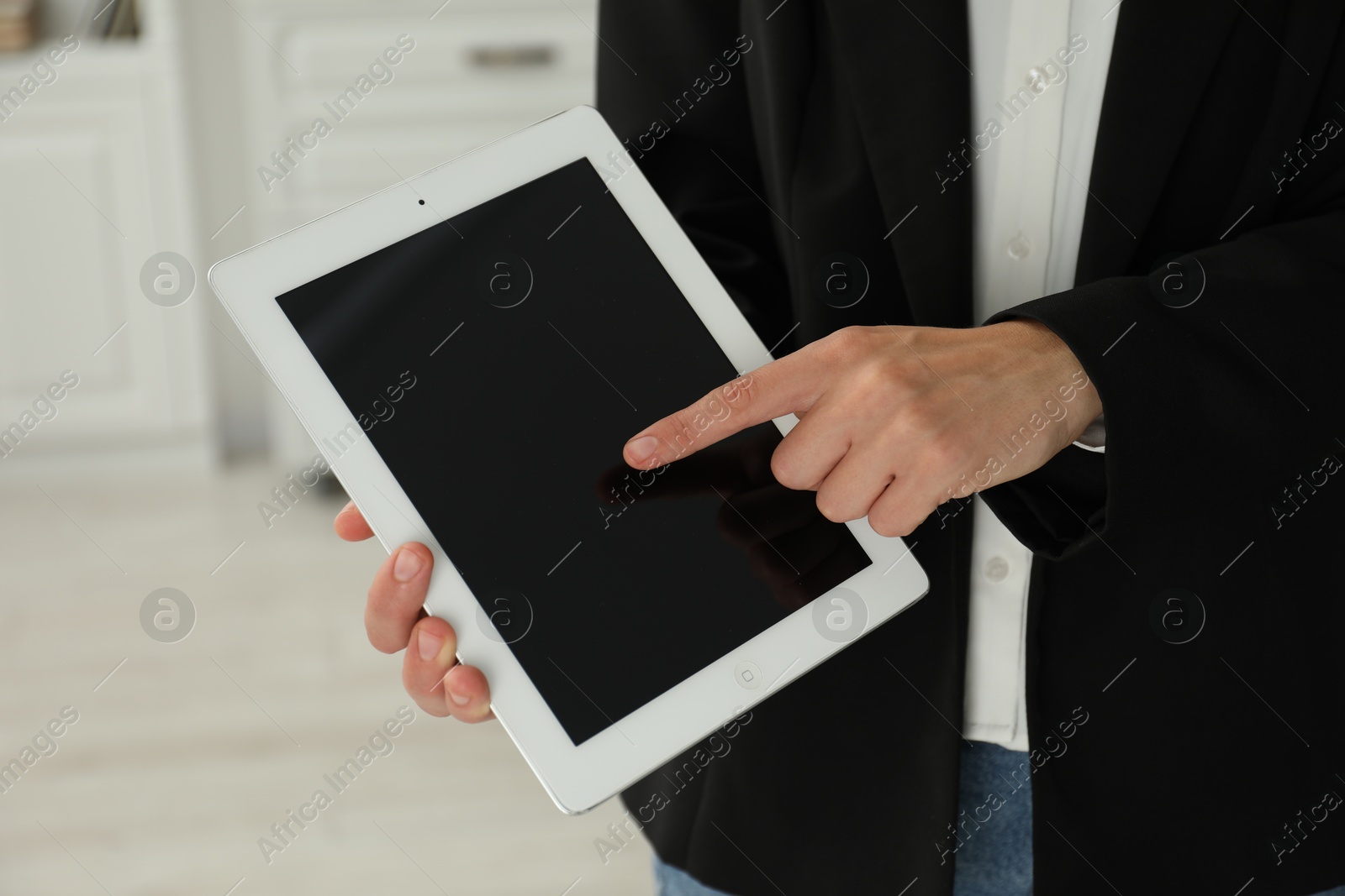 Photo of Businesswoman using tablet indoors, closeup. Modern technology