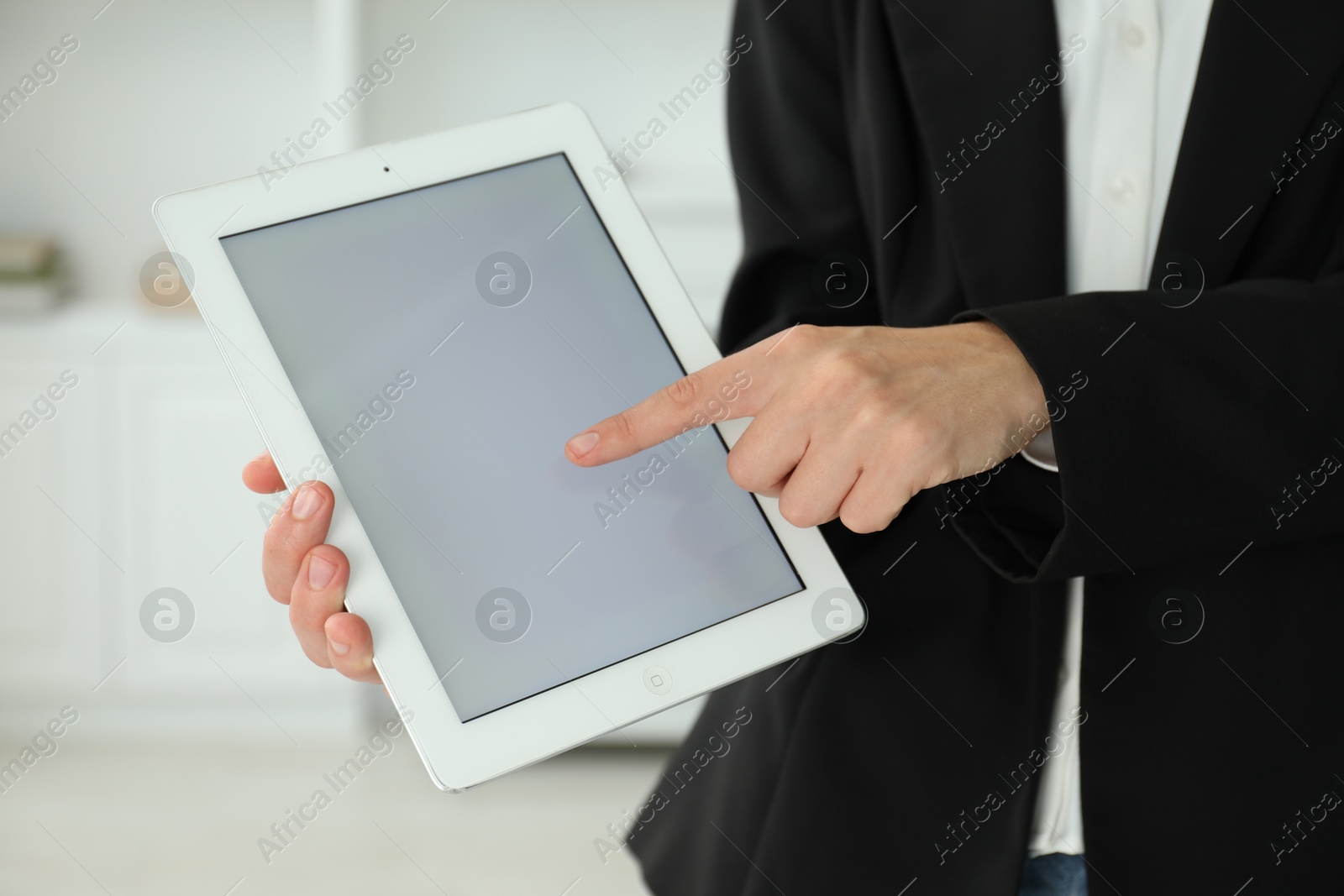 Photo of Businesswoman using tablet indoors, closeup. Modern technology