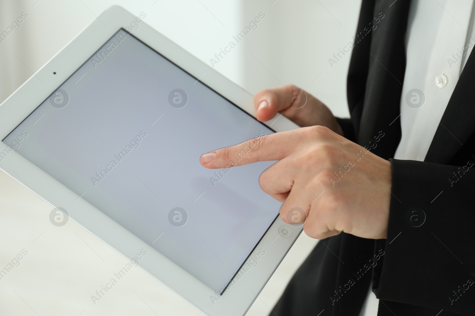 Photo of Businesswoman using tablet indoors, closeup. Modern technology