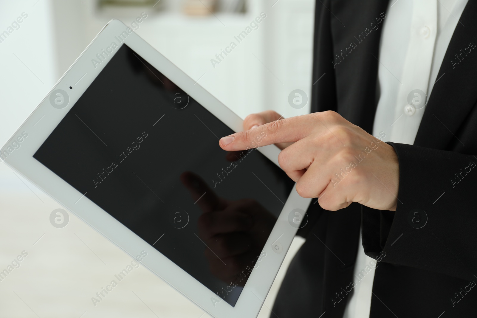 Photo of Businesswoman using tablet indoors, closeup. Modern technology