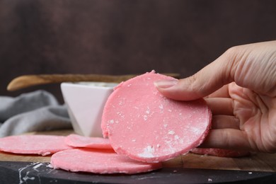 Photo of Woman making tasty mochi at wooden table, closeup