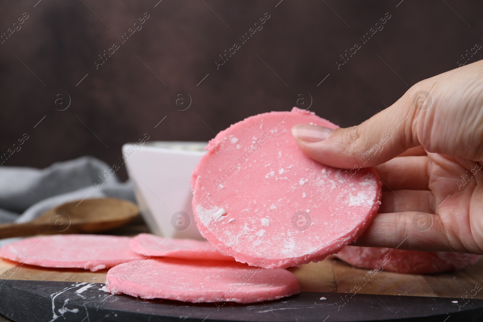 Photo of Woman making tasty mochi at wooden table, closeup